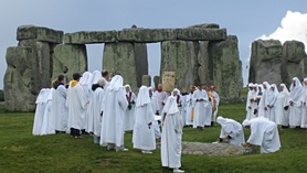 Druids celebrating at Stonehenge by sandyraid